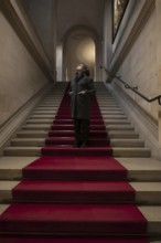 Woman Standing on a Red Carpet and Looking Up in Switzerland