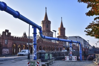 The Oberbaum Bridge over the Spree in Berlin-Friedrichshain, in the foreground, pipework for