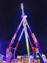 66 metre high ride Evolution at night at the Cranger Kirmes, Herne, Ruhr area, North