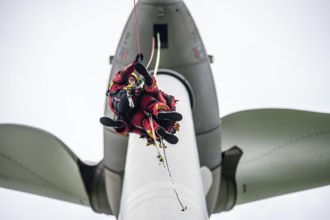 Height rescuers from the Gelsenkirchen fire brigade practise abseiling from a wind turbine from a