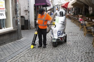 Street cleaner using vacuum machine, Maastricht, Limburg province, Netherlands