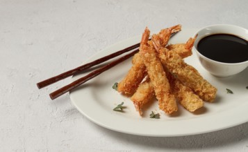 Fried shrimp, peeled in tempura, soy sauce, close-up