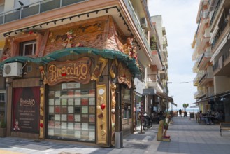 Exterior view of a shop with a unique fairy-tale style façade on a street, shop with sweets,