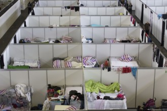 Temporary rooms with beds are set up in an emergency shelter for refugees on 9 December 2015 in a