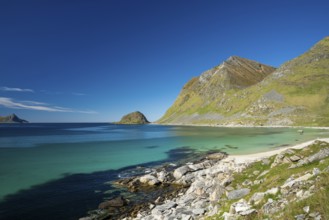 Landscape with sea at Haukland beach. On the right the mountains Veggen and Mannen. Shot during the