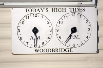 Two clocks showing times of high tides at Woodbridge, Suffolk, England, United Kingdom, Europe