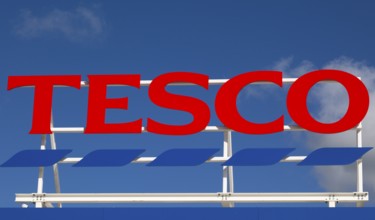 Sign for Tesco supermarket store against blue sky, Calne, Wiltshire, England, UK