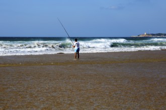 Man fishing from the beach at Conil de la Frontera, Cadiz province, Spain, Europe