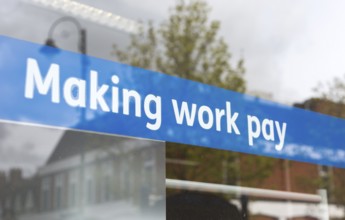 Making Work Pay banner in window of Jobcentre Plus office, Department for Work and Pensions,