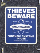 Close up of sign Thieves Beware Smartwater forensic systems in use, UK