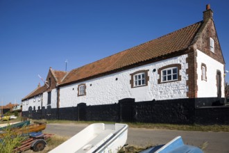 Whitewashed boathouse at the coastal village of Burnham Overy Staithe, north Norfolk coast,