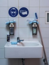 Washroom for workers in a company, hygiene measures, liquid soap and hand sanitiser