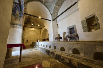 Interior of an old church in the Greek monastery with brick arches and an altar, Inside the