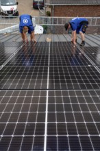 Installation of solar modules on the roof of a barn on a farm, over 240 photovoltaic modules are