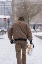 Winter in Frankfurt, UPS employee brings a parcel to a customer, on foot, because of the winter