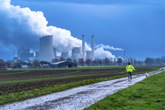 Field path, woman walking her dog, lignite-fired power plant, RWE Power AG Niederaußem power plant,