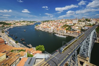 View of Porto city and Douro river and Dom Luis bridge I with metro tram from famous tourist