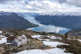 Hiker looking over the Sognefjord, half way up to Mt. Molden, Norway, Europe