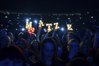 Fans hold up bright letters MATZE for Matthias Reim on the ..und plötzlich bist du Kult! Tour at