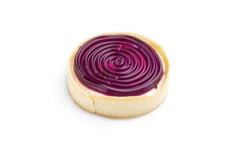 Single sweet tartlet with jelly and milk cream isolated on white background. Side view, close up