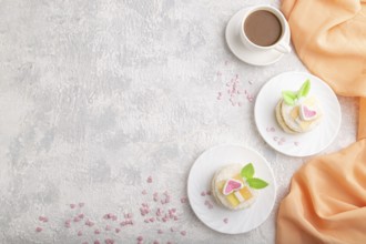 Decorated cake with milk and coconut cream with cup of coffee on a gray concrete background and