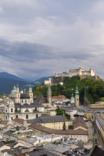 High-format photograph of the historic centre of Salzburg with the Hohensalzburg Fortress under a