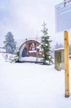 A festive nativity scene scene on a snow-covered site with small fir trees, Enzklösterle, Calw