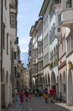 Bolzano, South Tyrol, Italy, Passers-by stroll through the Laubengasse in the old town centre,