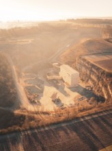 Industrial site and quarry in a hilly landscape at sunset, Magstadt, Germany, Europe