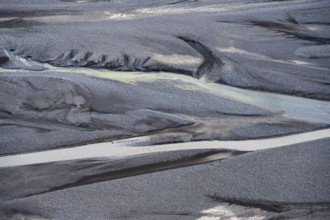 Detail, structure, river course in a gravel bed with black sand, meandering river, Dímonarhellir,