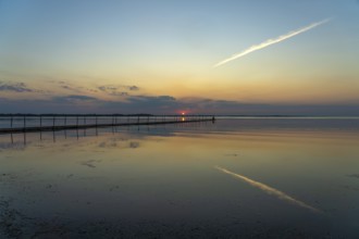 Sunset on a jetty in the Limfjord near Hvalpsund, Denmark, Europe