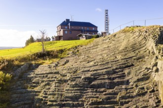 Basalt outcrop from a former quarry on the Hirstsein with mining hut, Erzgebirge, Marienberg