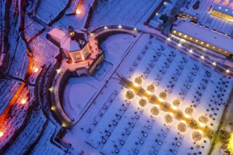 Aerial view of Wackerbarth Castle Park with Belvedere and vineyards with snow and Christmas lights,