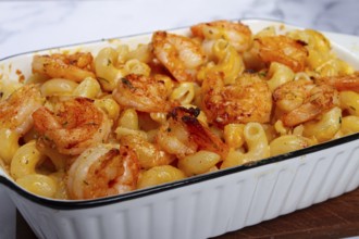 Pasta with shrimp and cheese, with a golden crust, cooked in a baking dish, homemade, no people