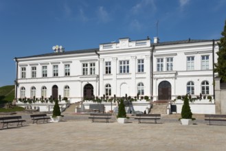 White, symmetrical building with architectural details, building near the Basilica of the Nativity