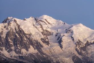 Evening mood with pink evening sky, mountain landscape at sunset, glaciated mountain peak of