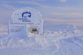 Sign, information board, icy, snowy, mountain landscape, Dempster Highway, Northwest Territories,