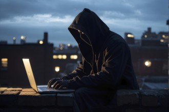 AI generated hooded man clutching a laptop symbolizing cyber criminality