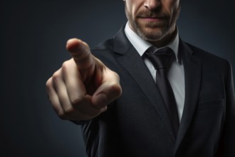 Man in suit pointing finger at camera in front of dark background. KI generiert, generiert AI