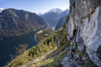 Mountaineers on a mountain hiking trail, Rinnkendlsteig, view of the Königssee, autumn forest and