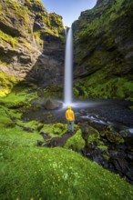 Tourist at Kvernufoss waterfall, in summer when the weather is nice, gorge and river, long