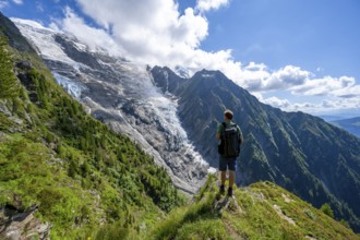 Mountaineer in front of impressive mountain landscape with glacier, view of glacier Glacier de