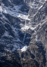 Waterfall of snow on a rock face, Watzmann east face in autumn with snow, Berchtesgaden National