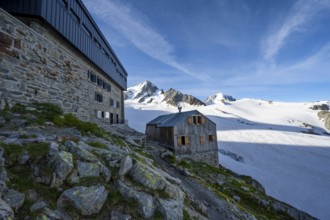 Old and new mountain hut Refuge Albert 1er, high alpine mountain landscape, summit of the Aiguille