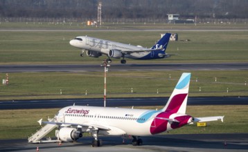 Düsseldorf Airport, Eurowings aircraft on the apron and SAS aircraft taking off, North