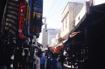 People shopping in the shady dark alleys of the souq market, Casablanca, Morocco, North Africa,