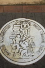 Round white marble plaque inscribed with the Italian words Parco Nazionale Delle Cinque Terre