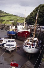 Boats in the harbour at low tide, Ilfracombe, North Devon, England, UK 1970s yacht Kiboko,