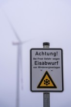 Sign warns of ice shedding from wind turbines, in frost, ice deposits can form on the rotors, ice