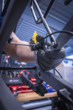 Close-up of a bicycle brake assembly process in a workshop, Waldbike Manufaktur, bicycle workshop,